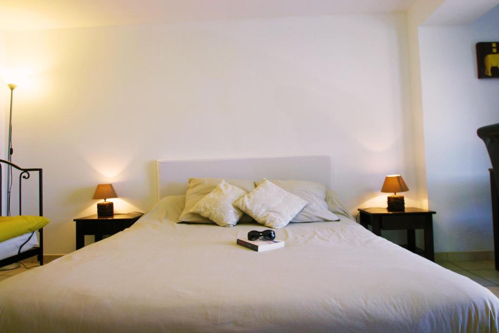 a bedroom with a bed with a book on it at Villa Ghiatone in Pietrosella