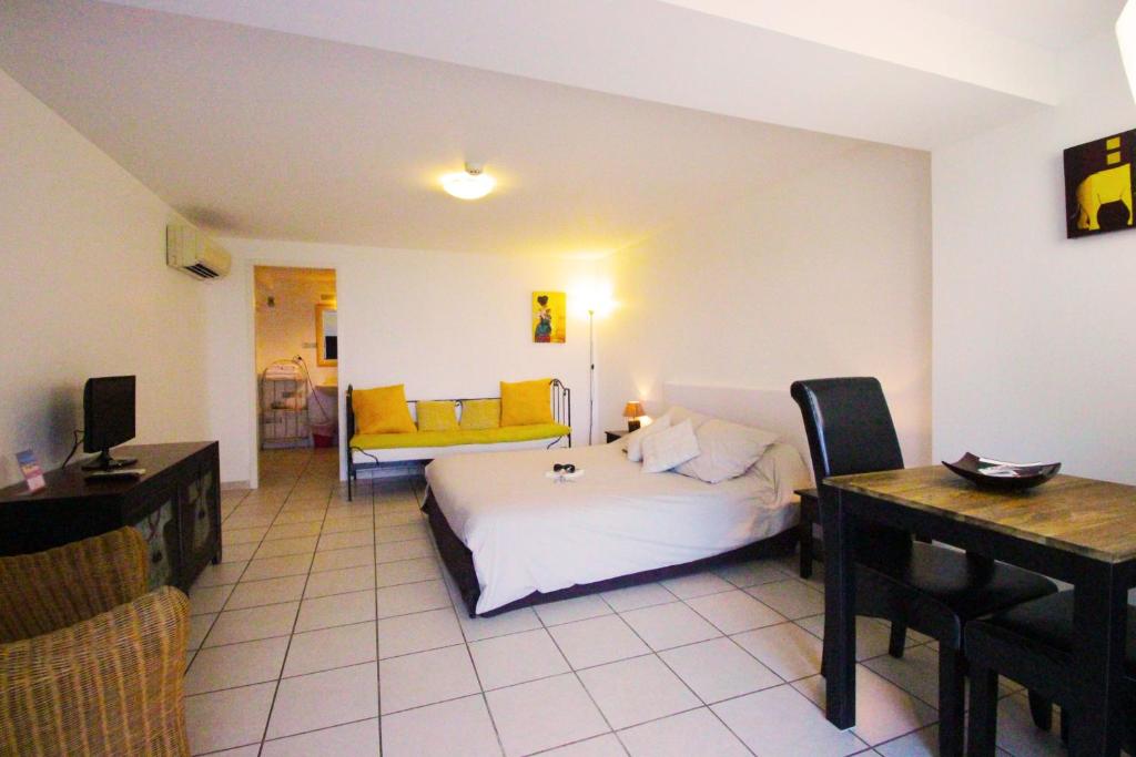 a bedroom with a bed and a table and a desk at Villa Ghiatone in Pietrosella