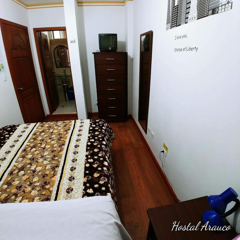 Postel nebo postele na pokoji v ubytování Hostal Arauco