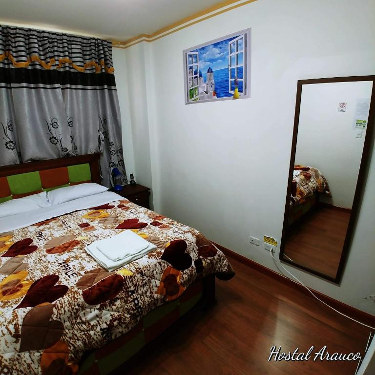 Postel nebo postele na pokoji v ubytování Hostal Arauco