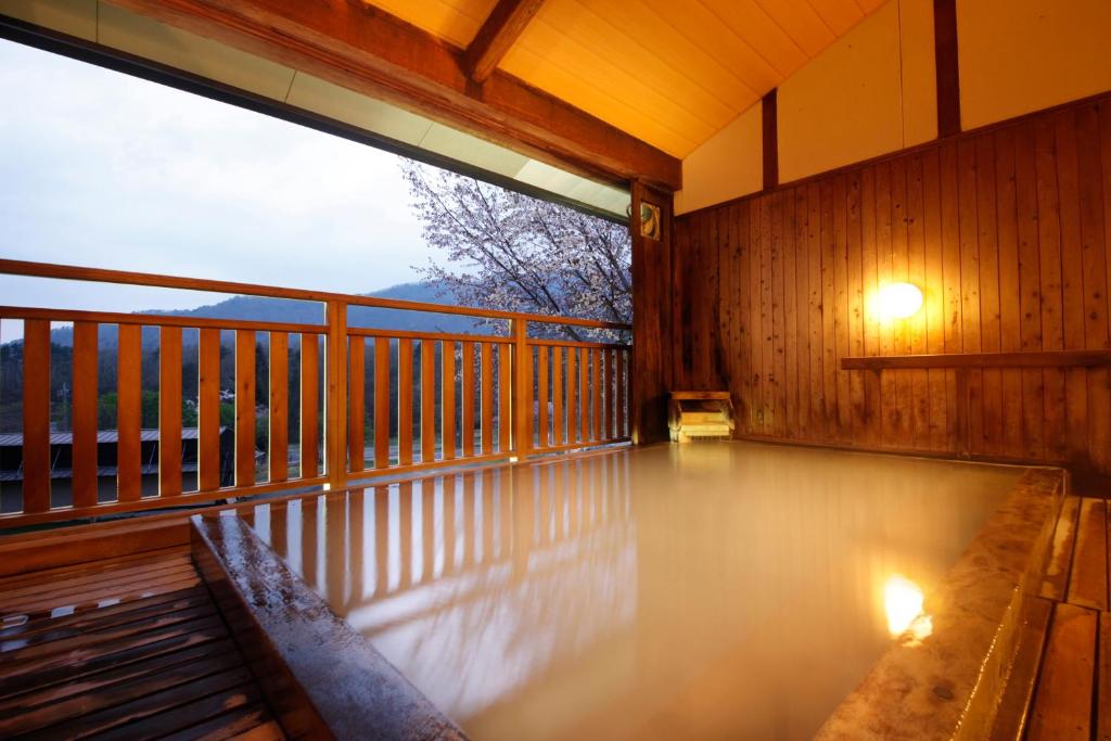 a porch with a bench on a balcony at Matsukaneya Annex in Zaō Onsen