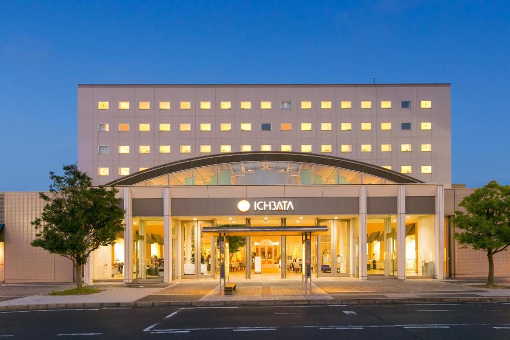 an exterior view of a building with an open entrance at Twin Leaves Hotel Izumo in Izumo