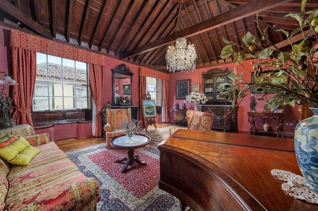 a living room with a couch and a table at Hotel Emblemático San Marcos in Icod de los Vinos