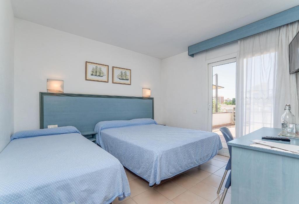 Postel nebo postele na pokoji v ubytování Hotel Platja d'Aro