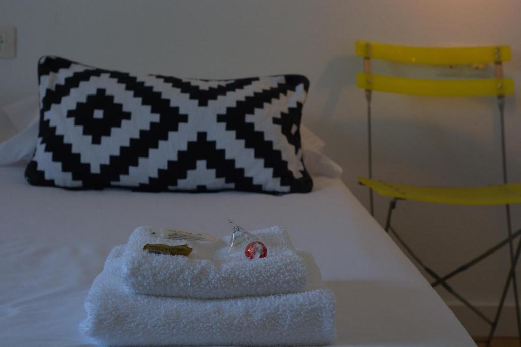 a white bed with a pillow and a towel on it at Pension Casa Pinilla in Cascante