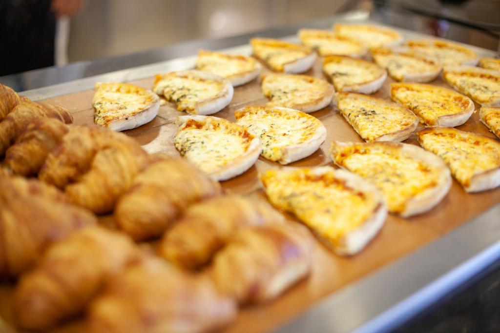 a bunch of pizzas on a table with bread at Grupotel Playa Club in Son Xoriguer