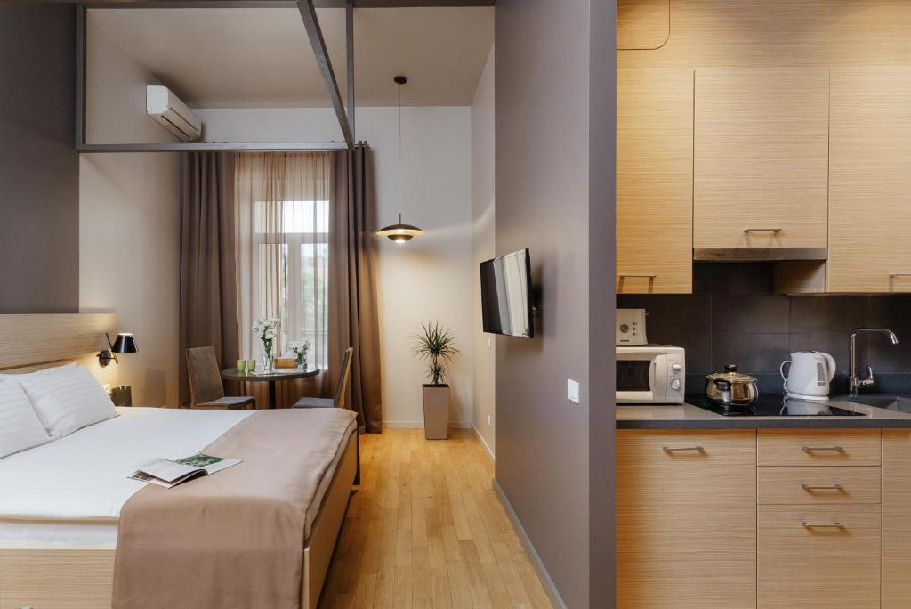 Postel nebo postele na pokoji v ubytování UNO Design Hotel