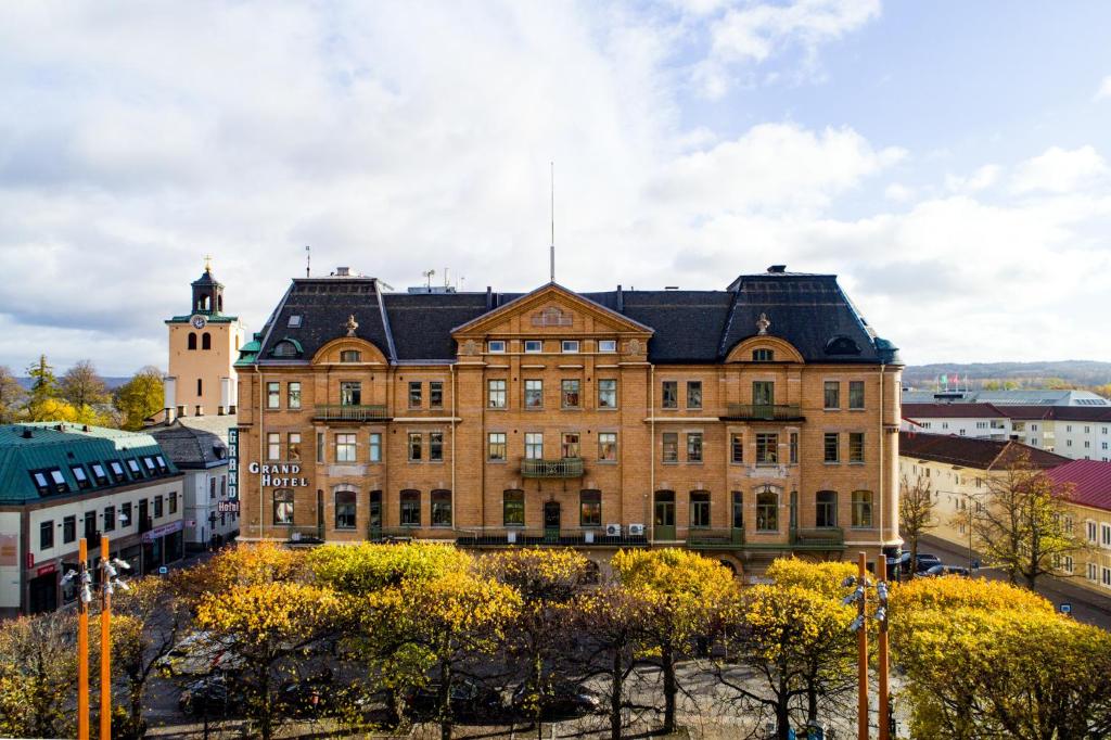 a large brick building with a black roof at Grand Hotel Jönköping in Jönköping