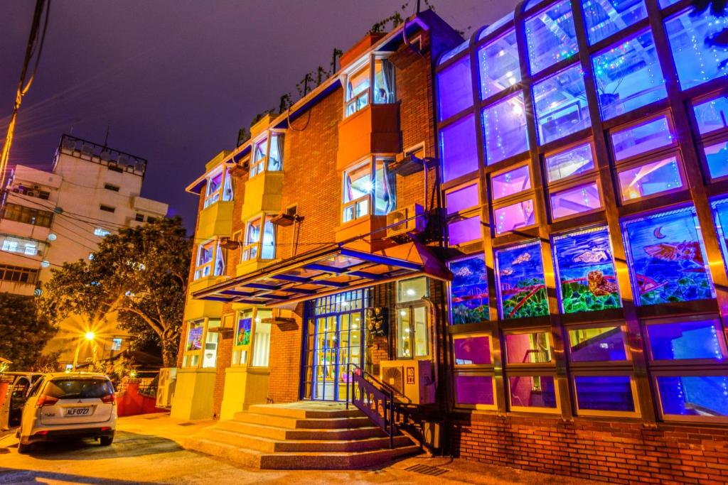 a building with purple and blue lights on it at Owl Castle in Hualien City