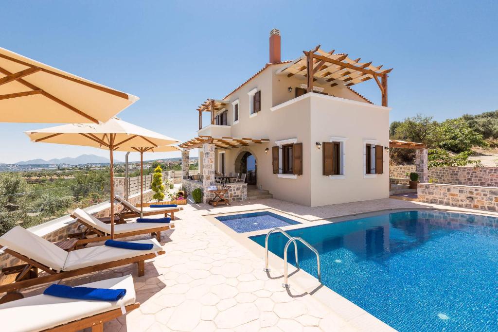 a villa with a swimming pool and a house at New Villa Katifes with Pool, Walk to Amenities & Amazing Views! in Kiriánna