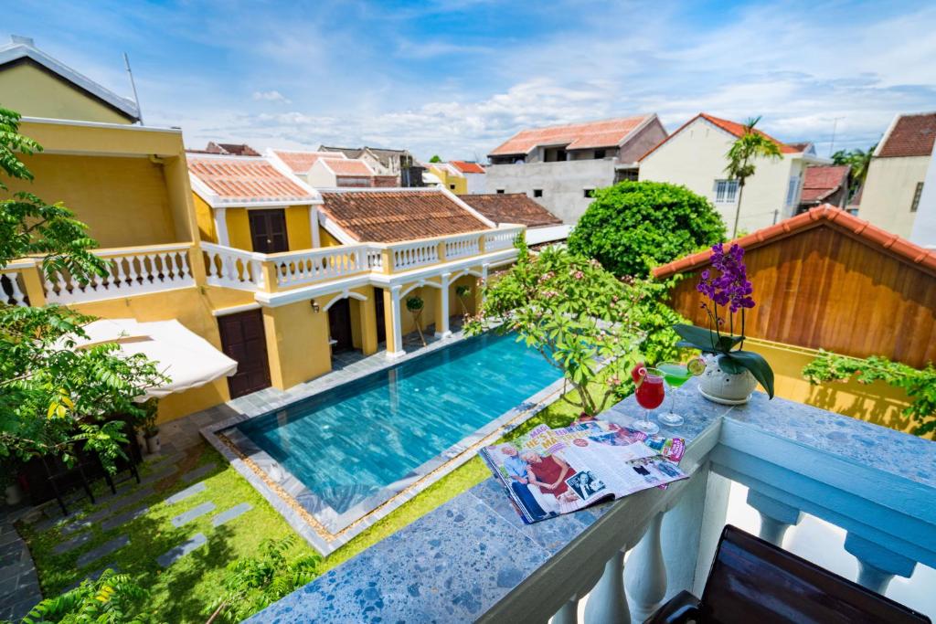 a view from the balcony of a house with a swimming pool at Hoian Central Hotel in Hoi An