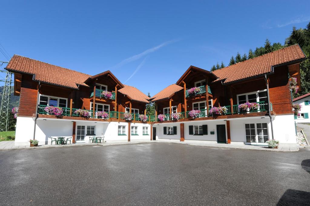 a large building with flowers on the balconies at Därfli Appartements in Sankt Gallenkirch