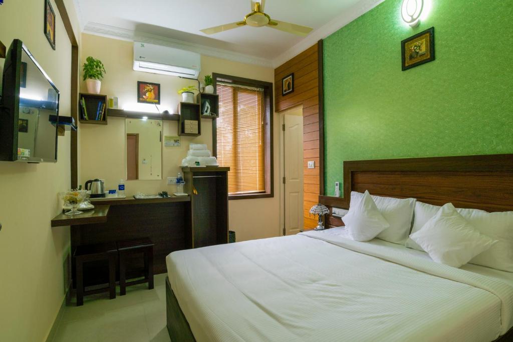 A bed or beds in a room at Blue Bell Cochin Airport Hotel