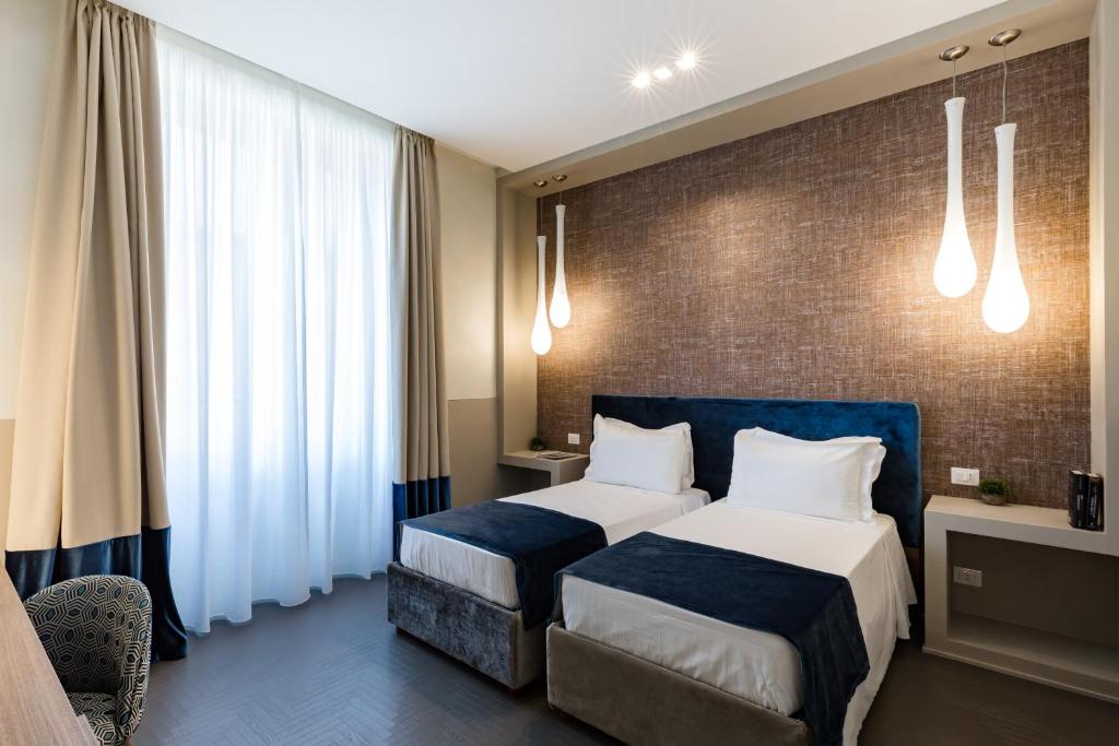 Postel nebo postele na pokoji v ubytování A World Aparts - Barberini Boutique Hotel