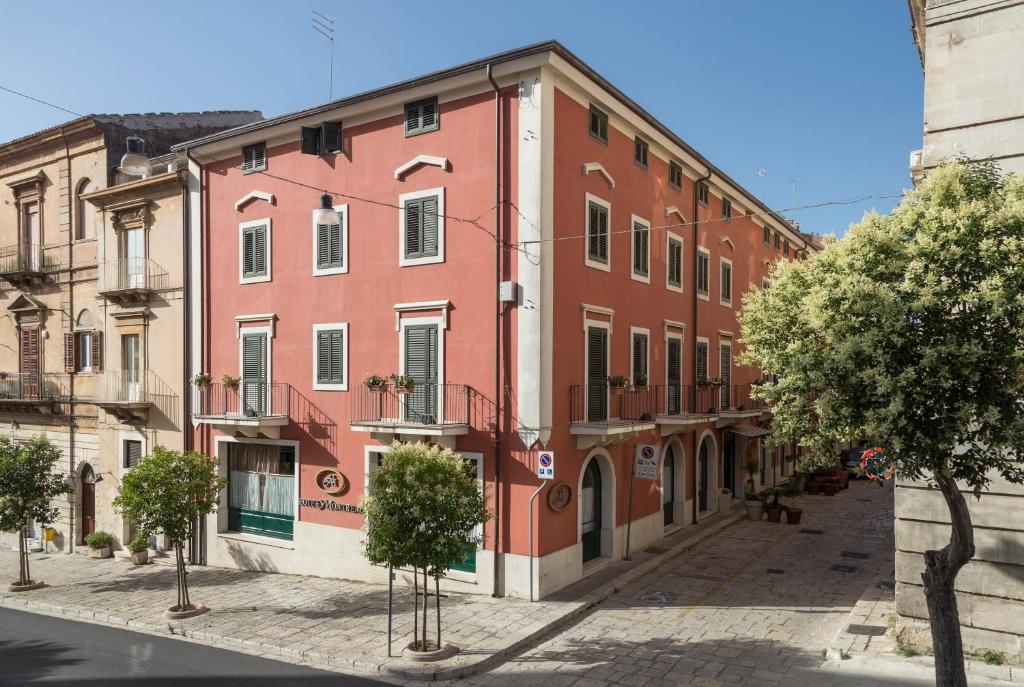 an old building with a red brick facade at Hotel Montreal in Ragusa
