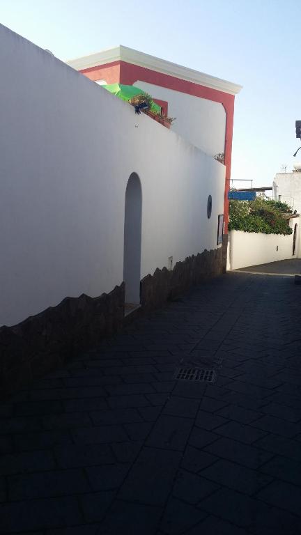 una pared blanca con un arco en el lateral de un edificio en casa u turcu en Stromboli