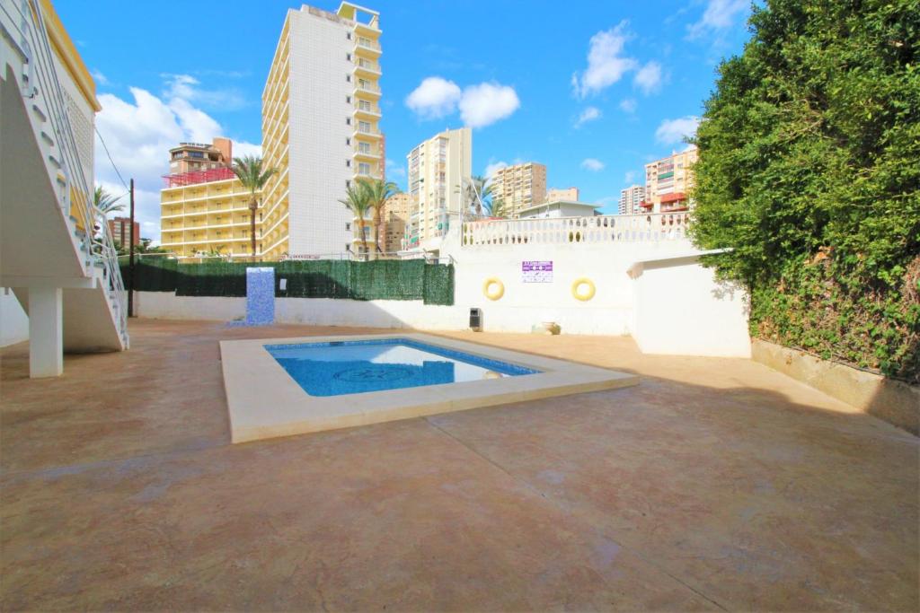 a swimming pool in a courtyard in a city at Apartamentos Lepanto 21 Levante Area in Benidorm