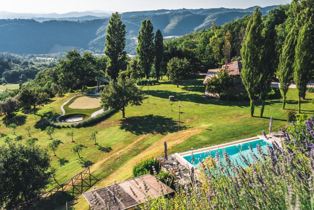 an estate with a swimming pool and mountains in the background at Nikis Resort in Gubbio
