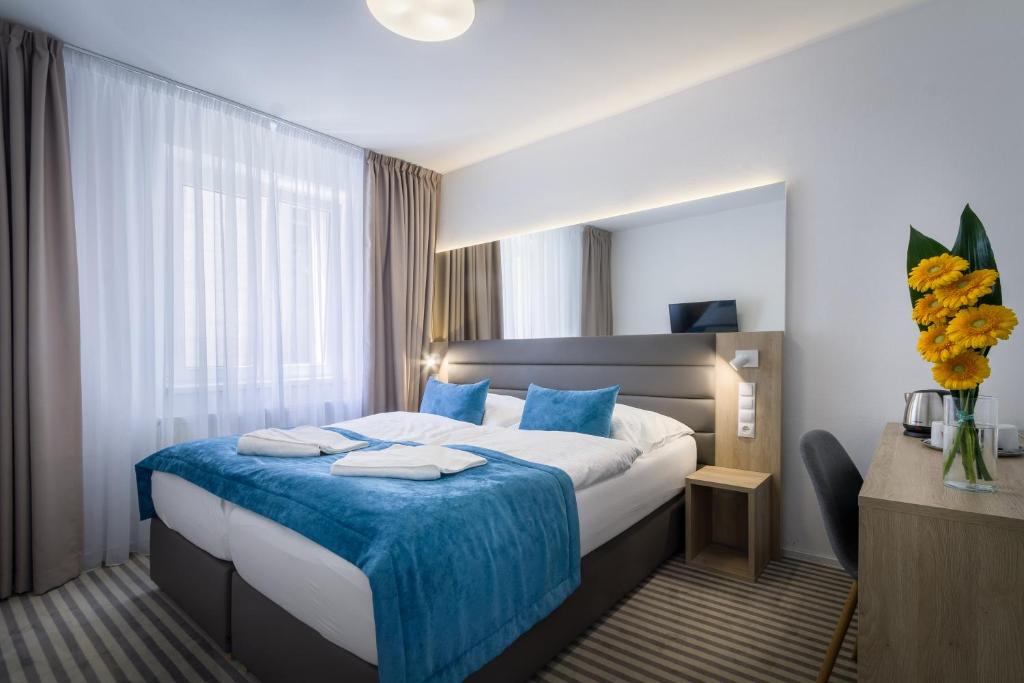 Ένα ή περισσότερα κρεβάτια σε δωμάτιο στο Hotel White Lion