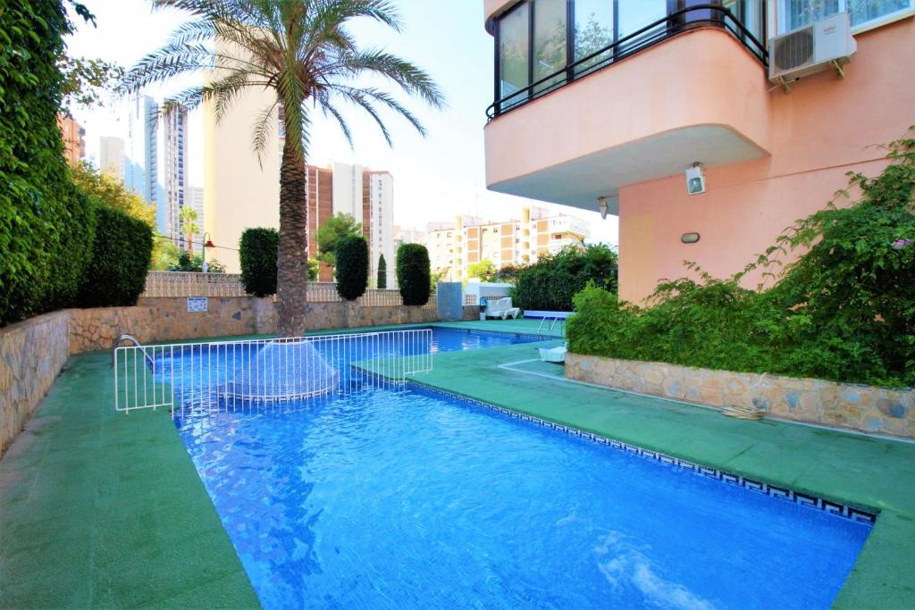 a swimming pool in front of a building at Cadiz 4-B in Benidorm