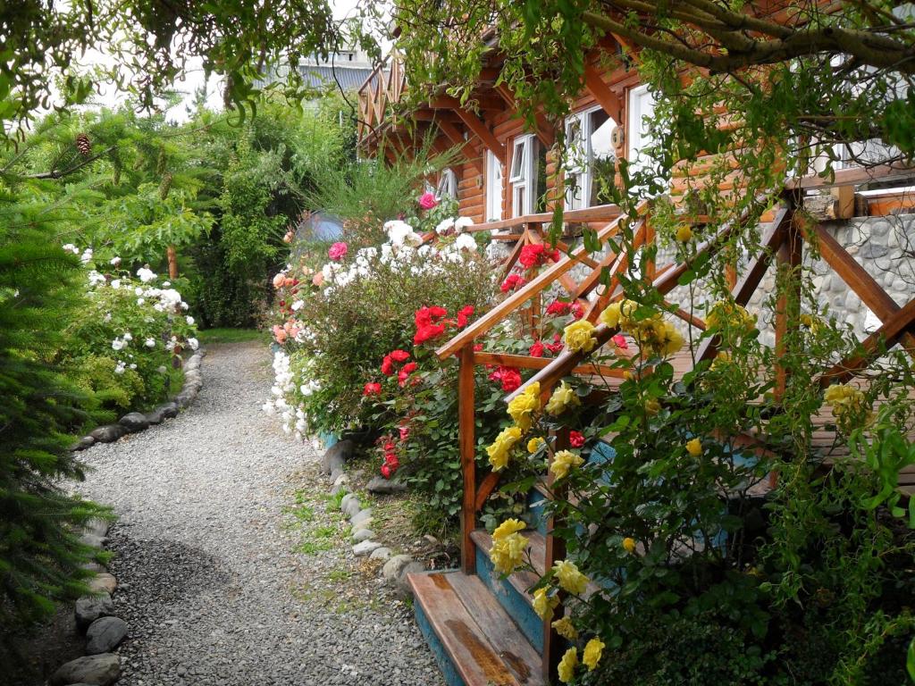 a garden with flowers in front of a house at Solares Del Sur in El Calafate