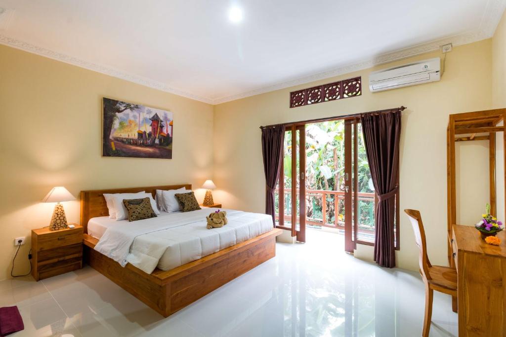 Postel nebo postele na pokoji v ubytování Alam Pangkung Ubud