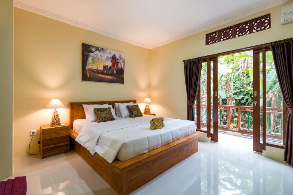 Postel nebo postele na pokoji v ubytování Alam Pangkung Ubud