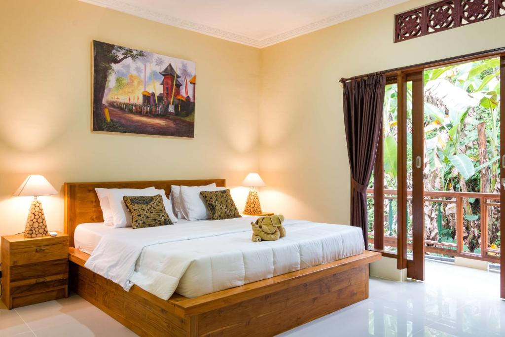 Postel nebo postele na pokoji v ubytování Alam Pangkung Ubud