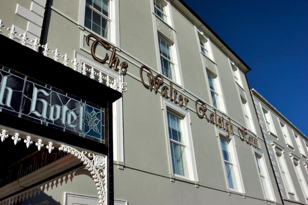 
a building with a sign on the front of it at Walter Raleigh Hotel in Youghal
