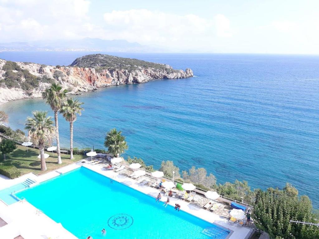 a swimming pool with a view of the ocean at Istron Bay Hotel in Istro
