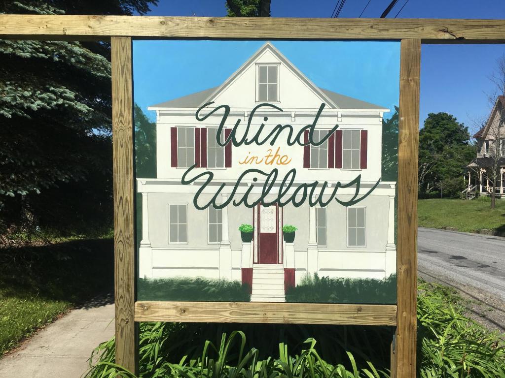 a sign for a white house with the words wind in the window at Wind in the Willows Overnight in Jefferson