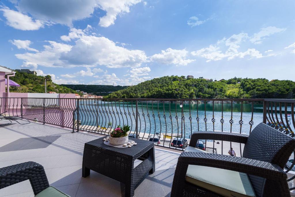 a balcony with chairs and a view of the water at Apartment NewCity in Novigrad Dalmatia