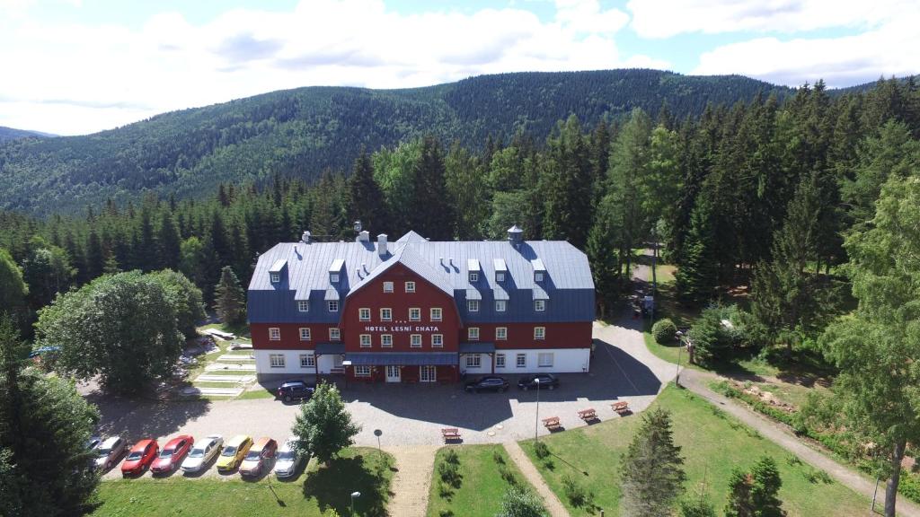 an aerial view of a large house in the mountains at Hotel Lesní Chata in Kořenov