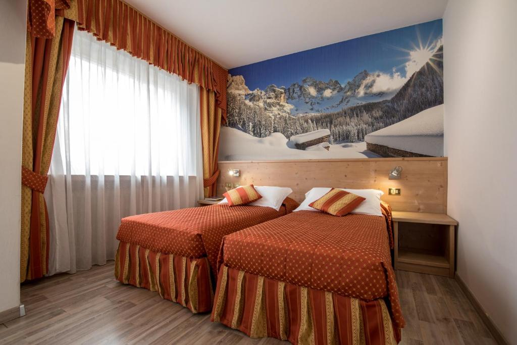 Postel nebo postele na pokoji v ubytování Hotel Touring