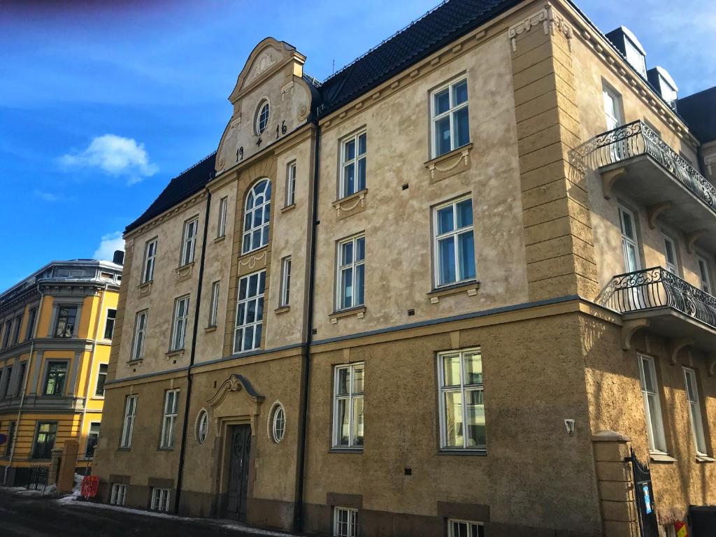 an old brick building with a clock tower at The Apartments Company - The Sweet in Oslo