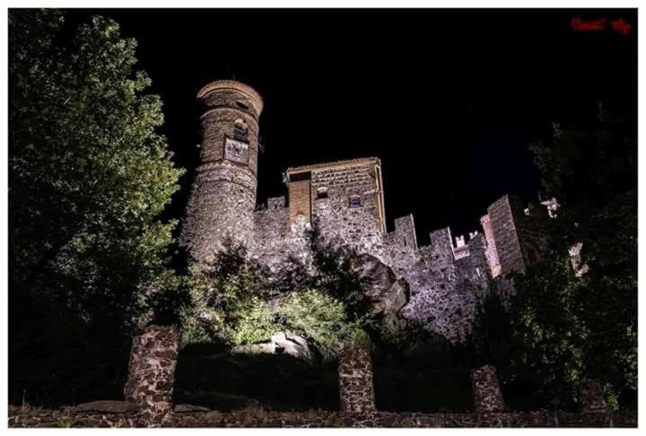 an old castle with a clock tower on top of it at B&B sotto le mura in Pavone Canavese