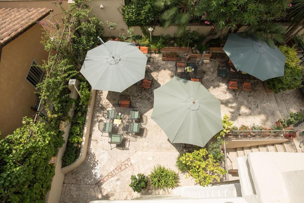 an overhead view of a patio with two umbrellas at Hotel Villa Delle Rose in Rome