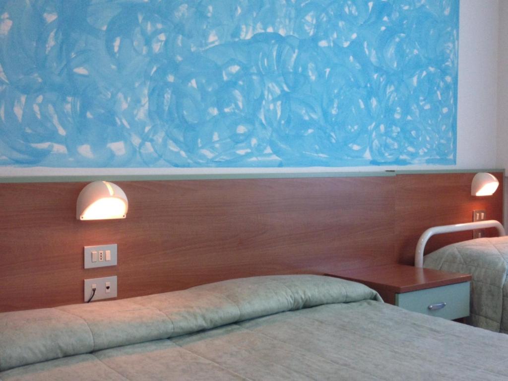 Postel nebo postele na pokoji v ubytování Hotel Rivamare