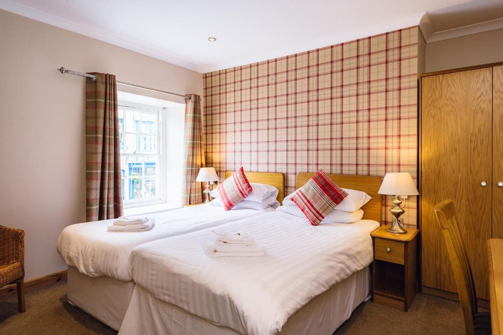 a bedroom with two beds and a window at Elan Hotel in Rhayader