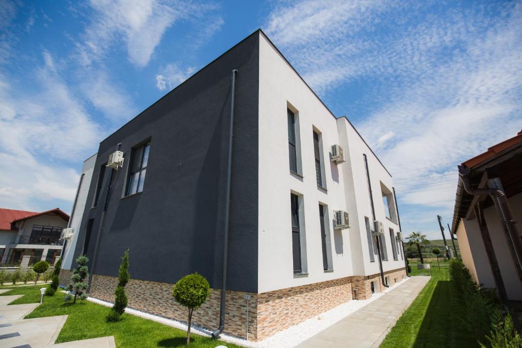 a black and white building with a brick at Palm Rezidential in Sebeş