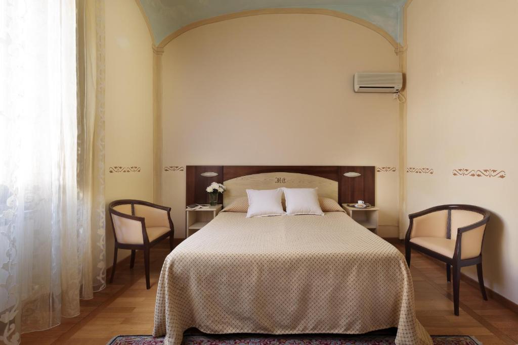 Postel nebo postele na pokoji v ubytování Hotel Dei Capitani