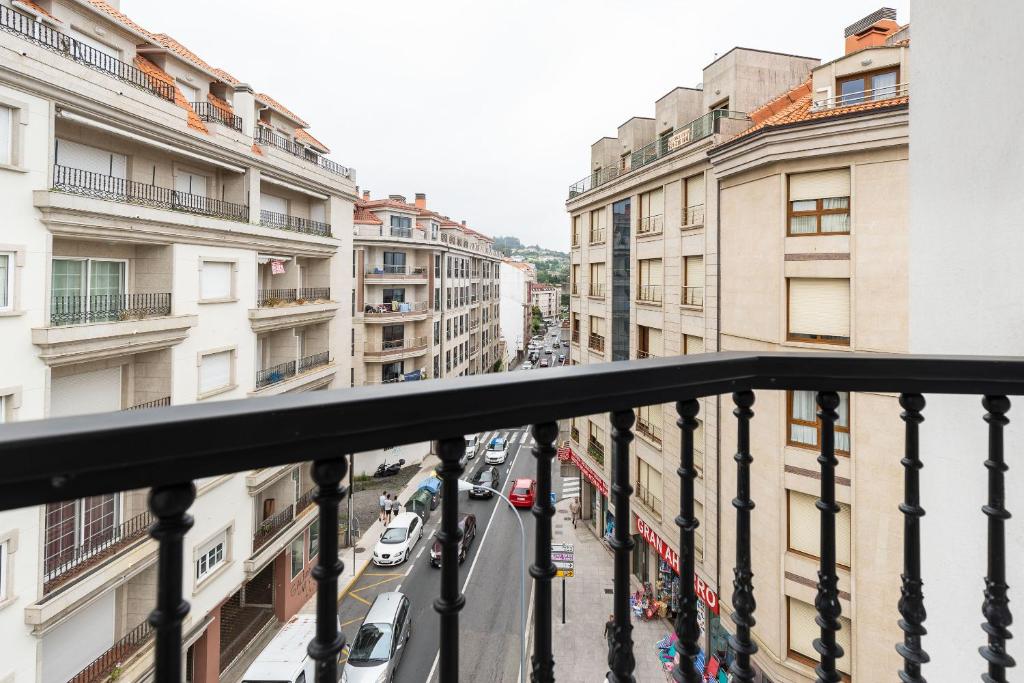 a view of a city street from a balcony at Hotel Panadeiramar in Sanxenxo