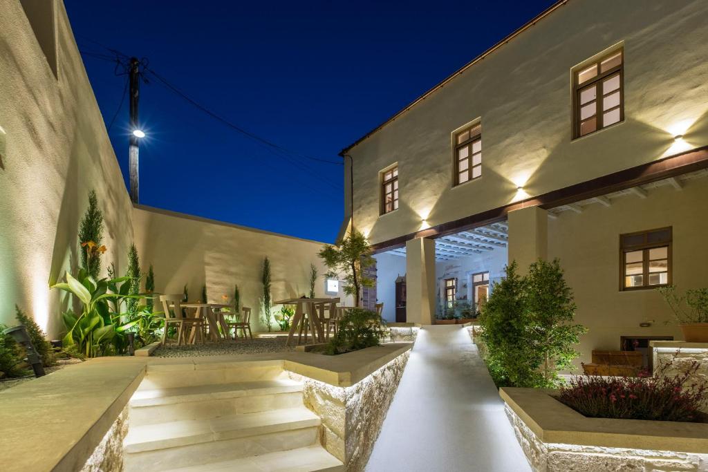 an exterior view of a building with a patio at Aelios Design Hotel in Chania