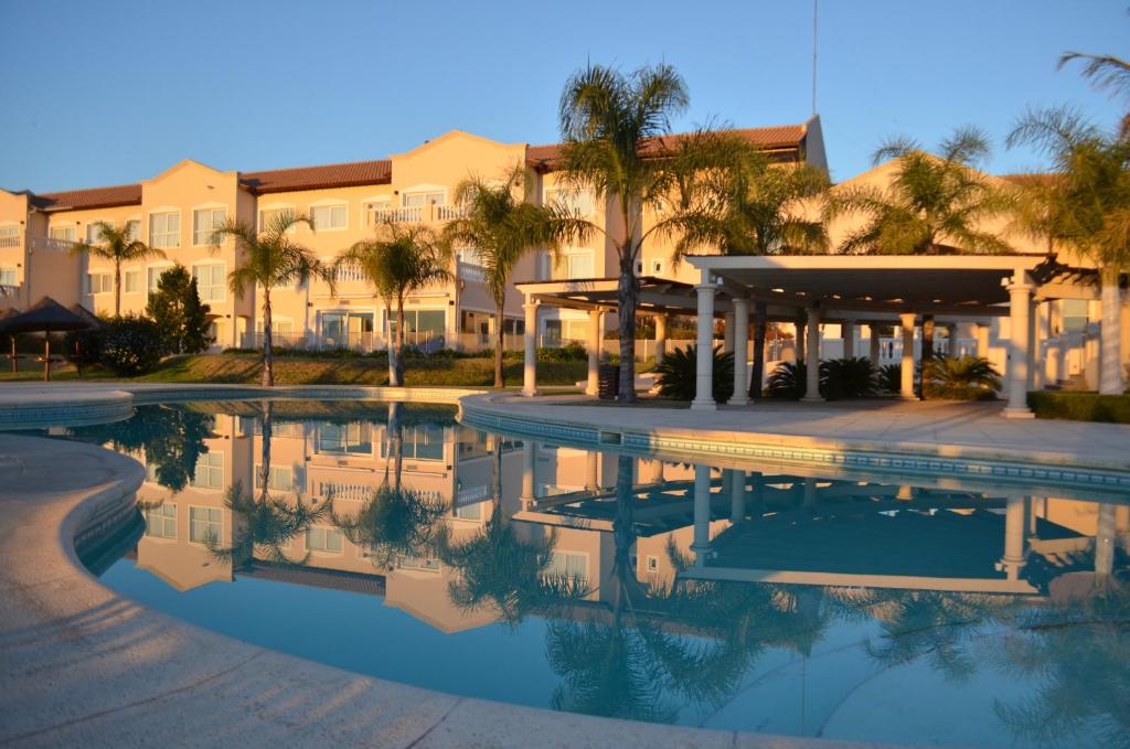 ein Hotel mit einem Pool vor einem Gebäude in der Unterkunft Howard Johnson Resort Spa & Convention Center in Merlo