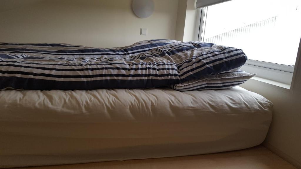 Postel nebo postele na pokoji v ubytování Vatnsás 10