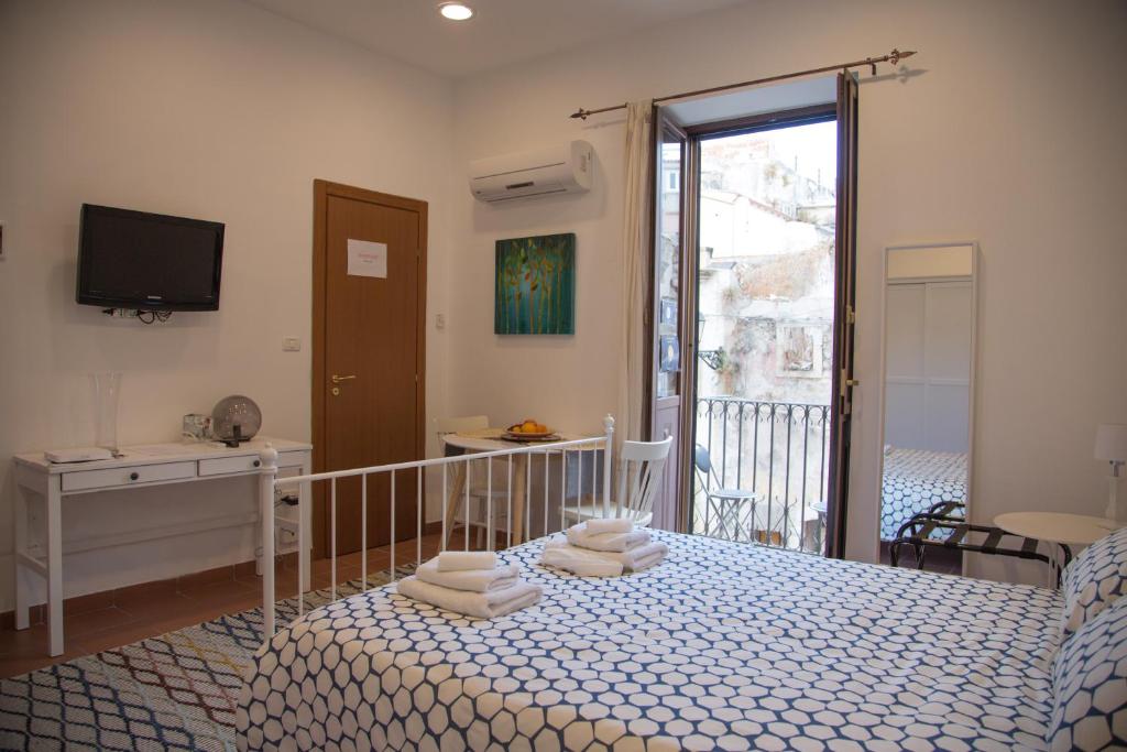 Postel nebo postele na pokoji v ubytování Casa Miele Ortigia