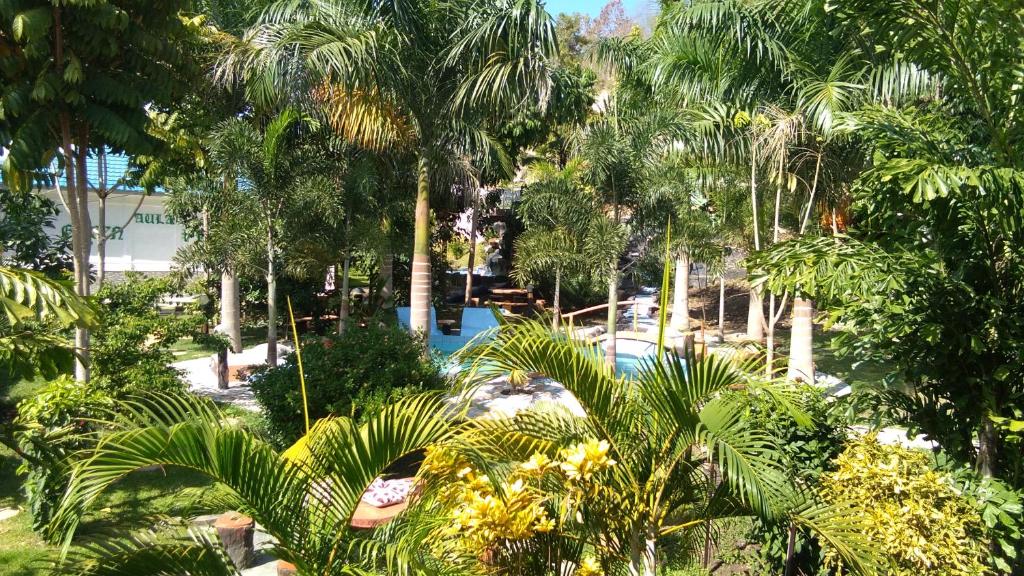 an aerial view of a resort with palm trees and a pool at Hotel Green Prundi in Labuan Bajo