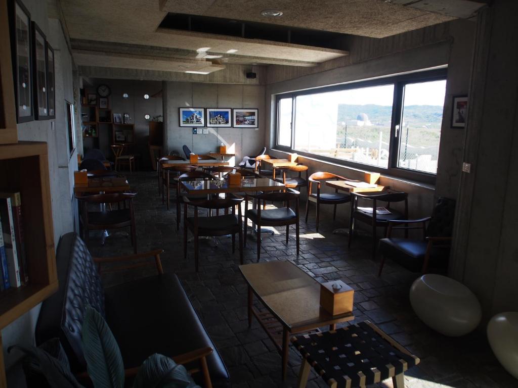 a restaurant with tables and chairs and a large window at The Light in Hengchun South Gate