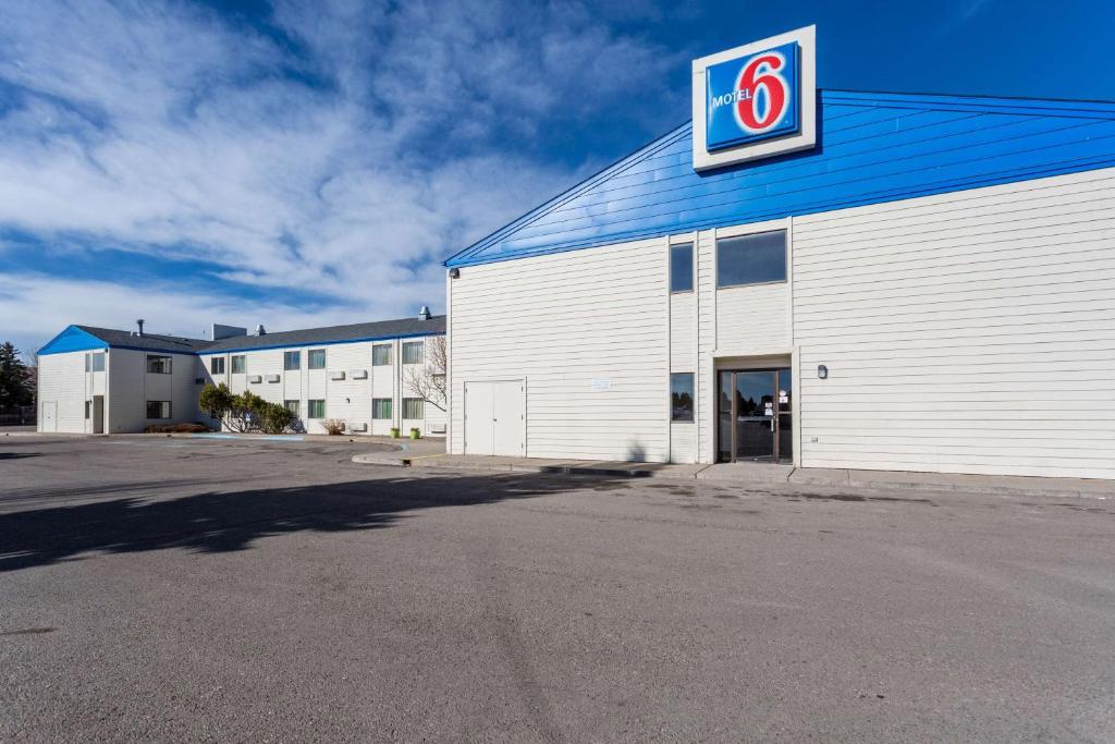 a building with a sign on the side of it at Motel 6-Great Falls, MT in Great Falls