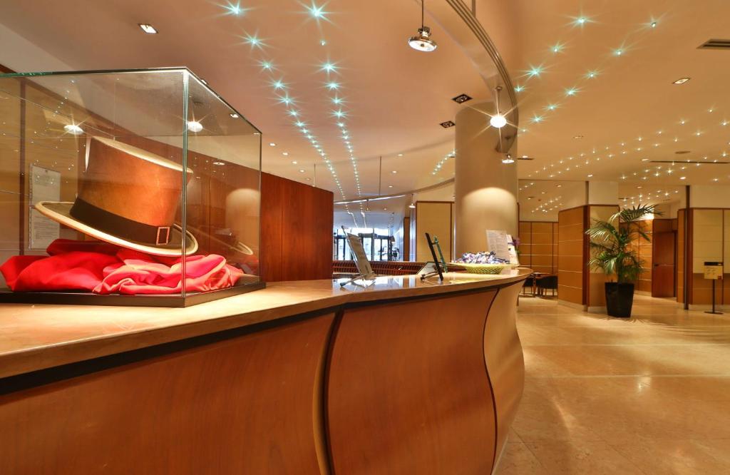 a lobby with a counter with a hat on it at Hotel Cappello D'Oro, BW Signature Collection in Bergamo